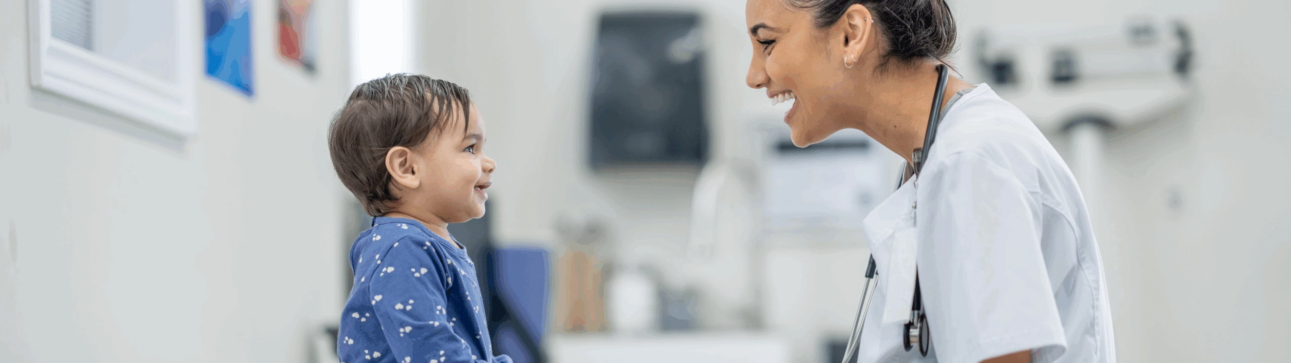 Young female nurse interacting with a very cute baby.