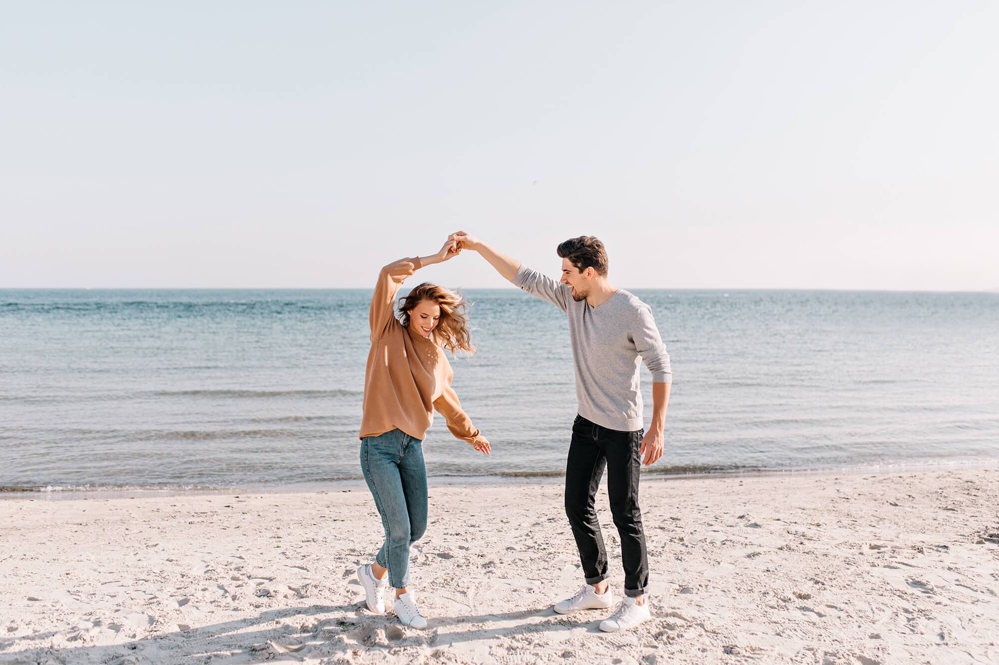 Young couple dancing on the beach.