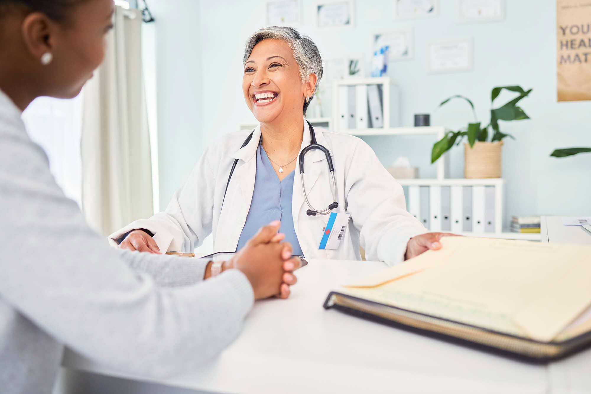 happy-doctor-patient-and-talking-at-consultation-2025-04-06-09-29-33-utc-2.jpg